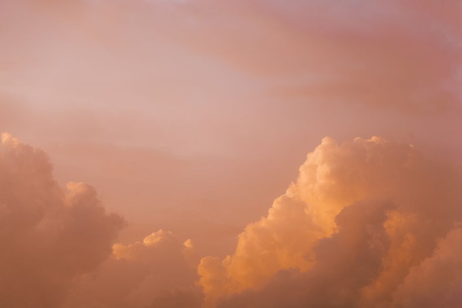 Capture of peach-colored clouds during sunset, perfect for serene backgrounds.