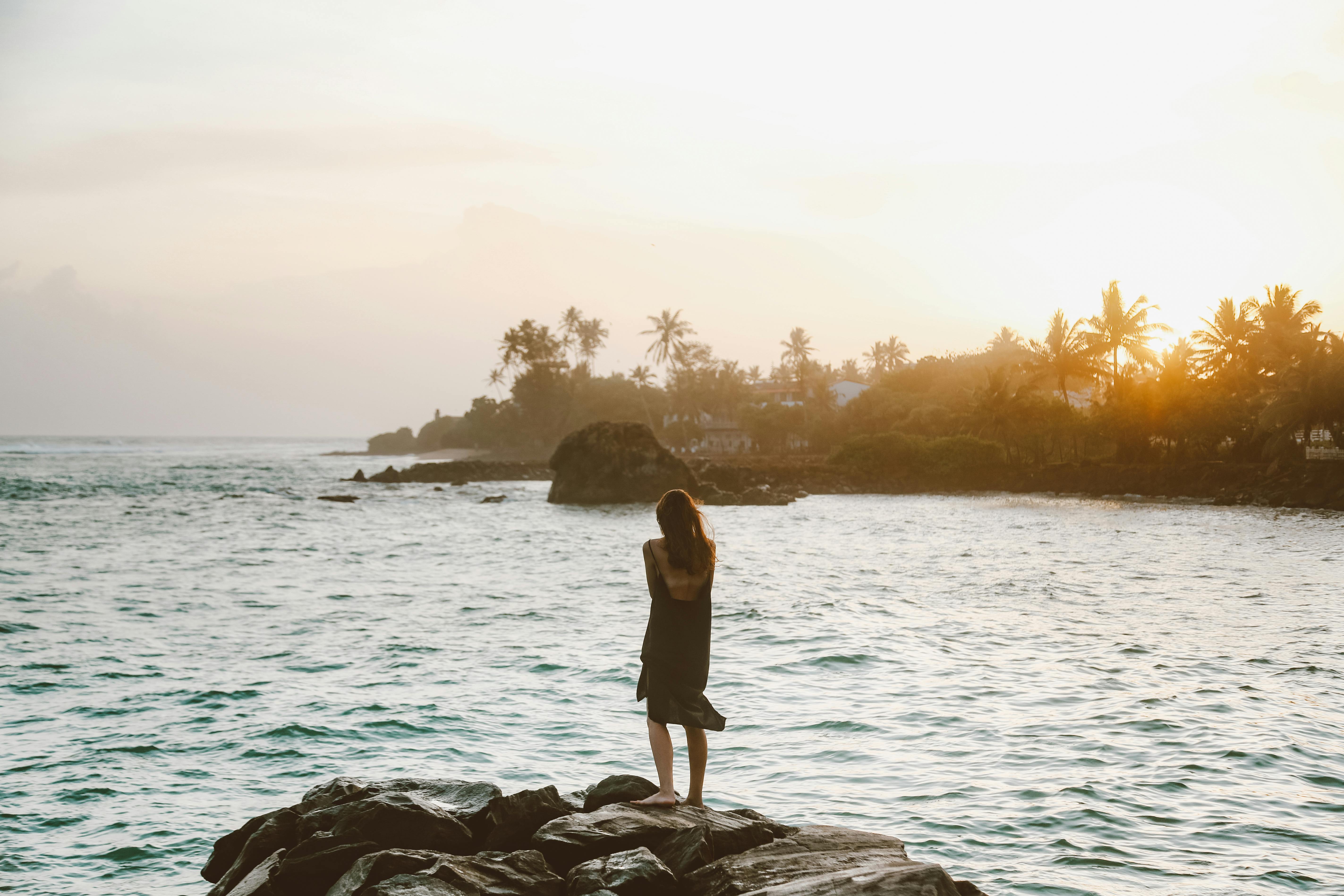 Woman Standing and Looking at Sea at Sunset · Free Stock Photo