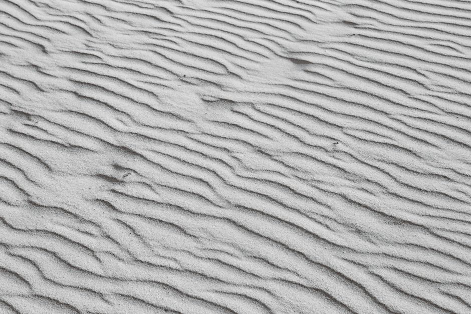 Captivating pattern of rippling sand in coastal desert dunes.