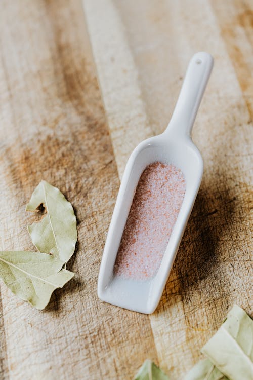 A Close-Up Shot of Himalayan Salt on a Ceramic Scooper