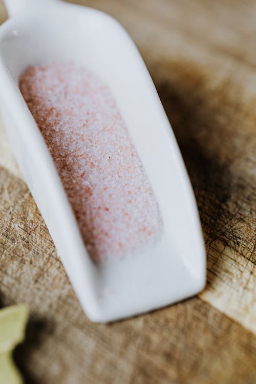 A Close-Up Shot of Himalayan Salt on a Ceramic Scooper