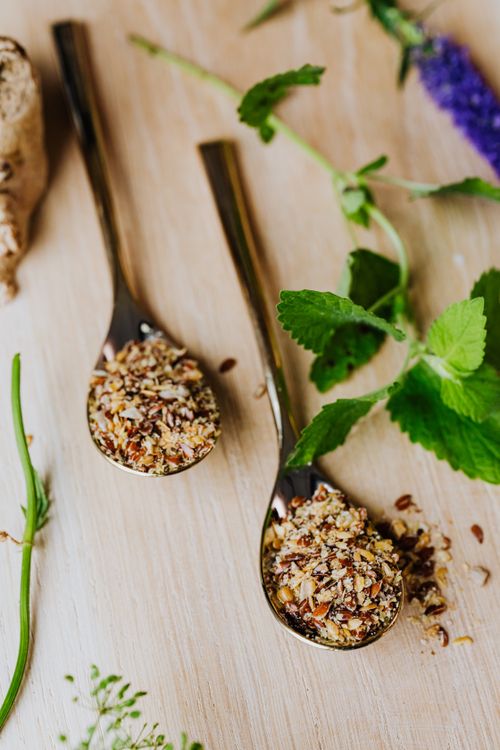 Free Elegant arrangement of dried herbs and spices in spoons with fresh greens. Stock Photo