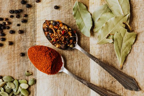 Free Overhead view of mixed spices in spoons on a rustic cutting board. Stock Photo