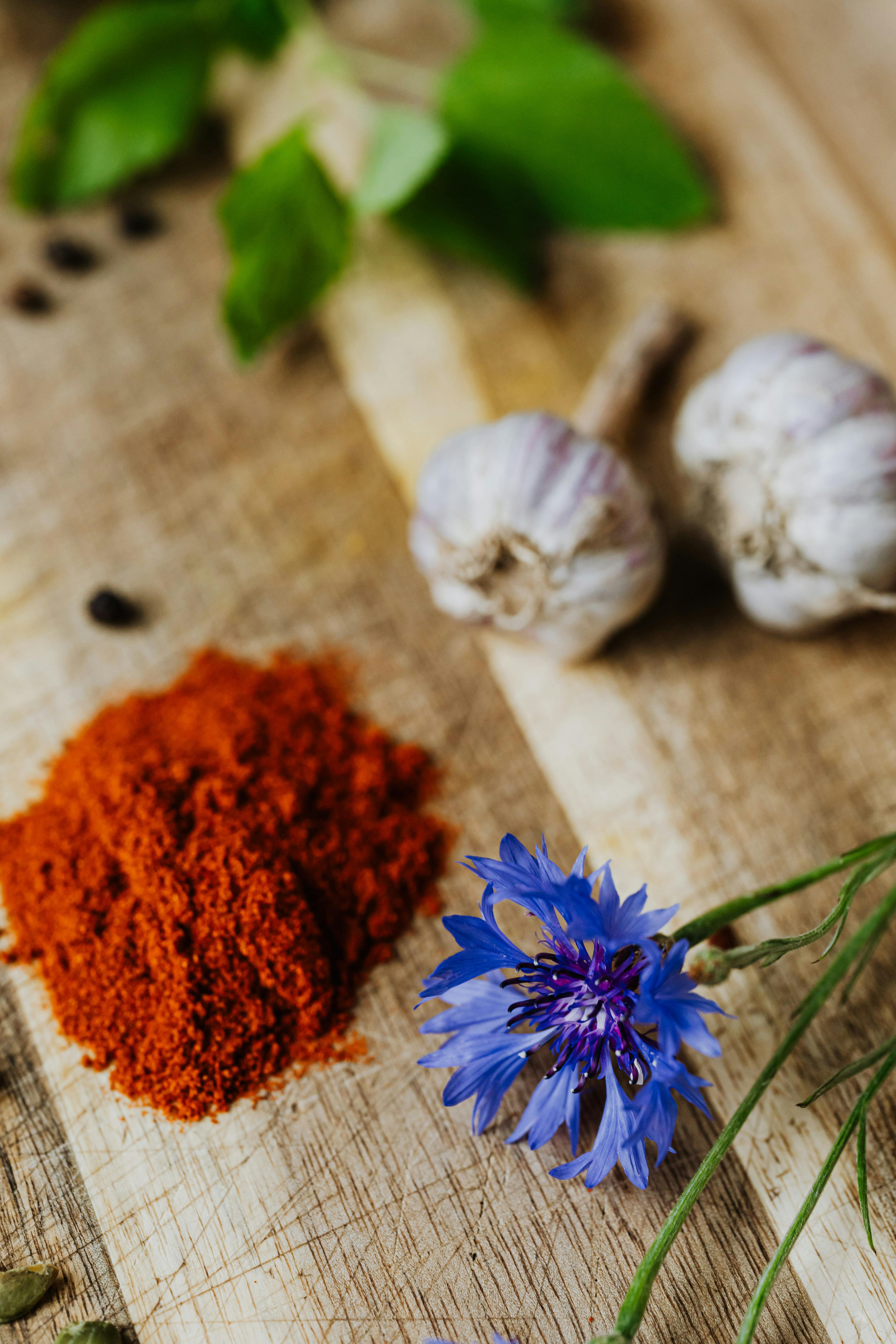CloseUp Shot of Paprika, Flower and Garlics · Free Stock Photo