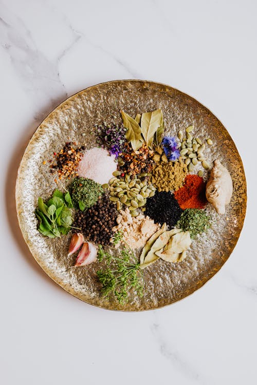 Various Spices and Herbs on Brown Round Plate · Free Stock Photo