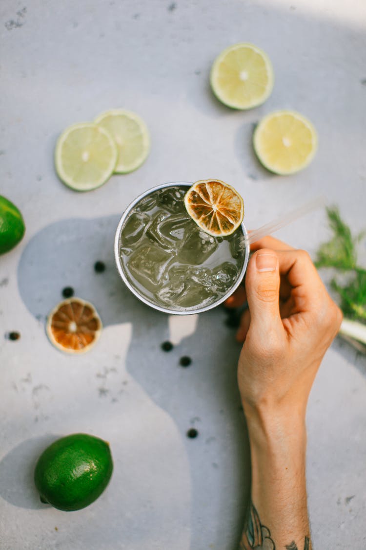 Hand Holding Cup Of Iced Lemonade