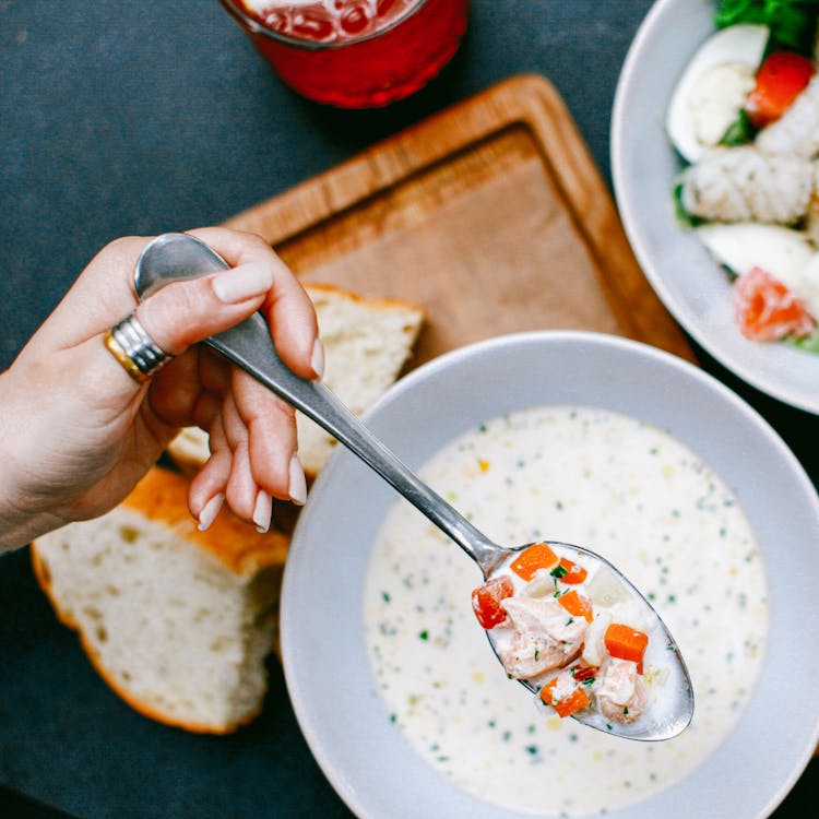 Close Up Of A Person Eating Soup