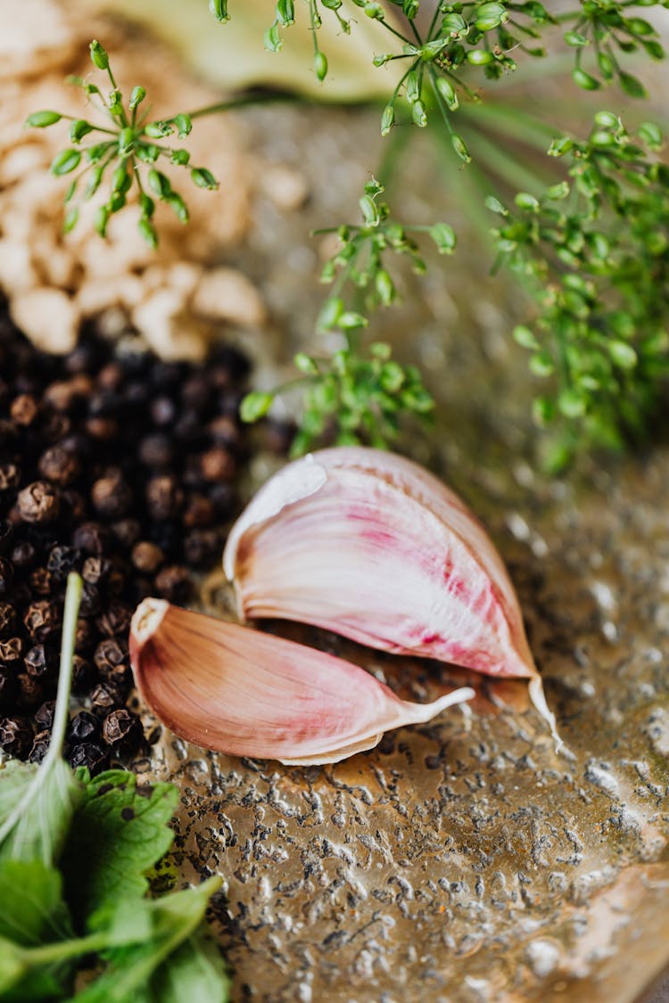 Garlic Cloves Beside Spices And Leaves