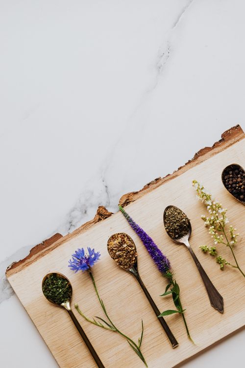 Free Close-up of various herbs and flowers in spoons on a wooden board, perfect for natural remedies. Stock Photo