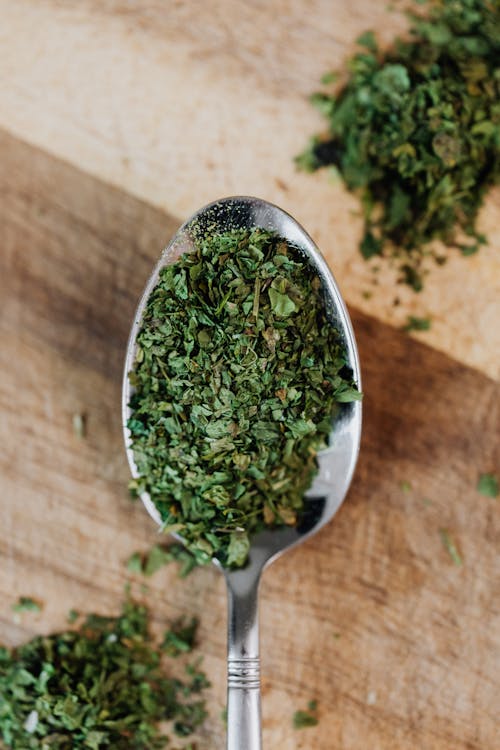 Close-Up Photo of Green Oregano on a Spoon