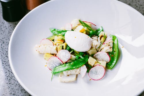 Photograph of a Dish with Radish an Snap Peas