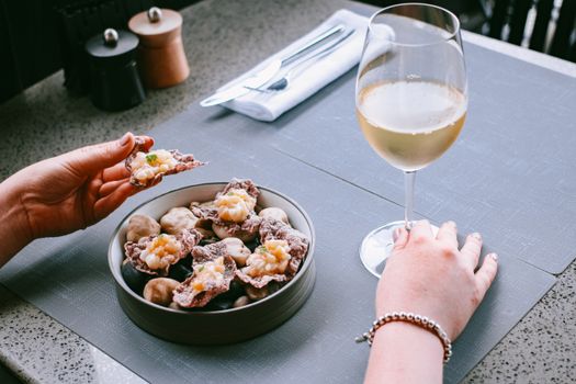 A stylish table setting with appetizers and white wine, perfect for fine dining ambiance.