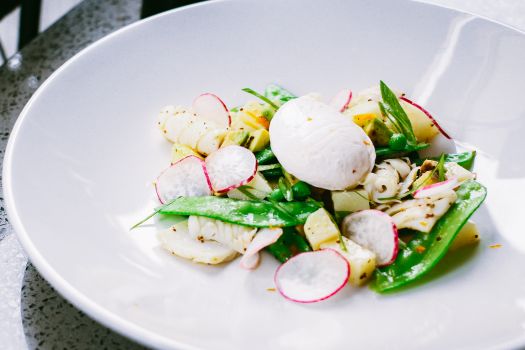 A vibrant vegetable salad with a poached egg, perfect for a healthy meal.