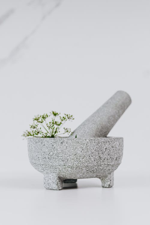 Photograph of a Mortar and Pestle on a White Surface