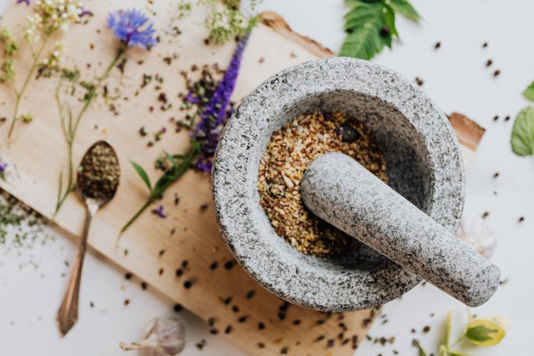 Gray Mortar And Pestle With Ground Spice 