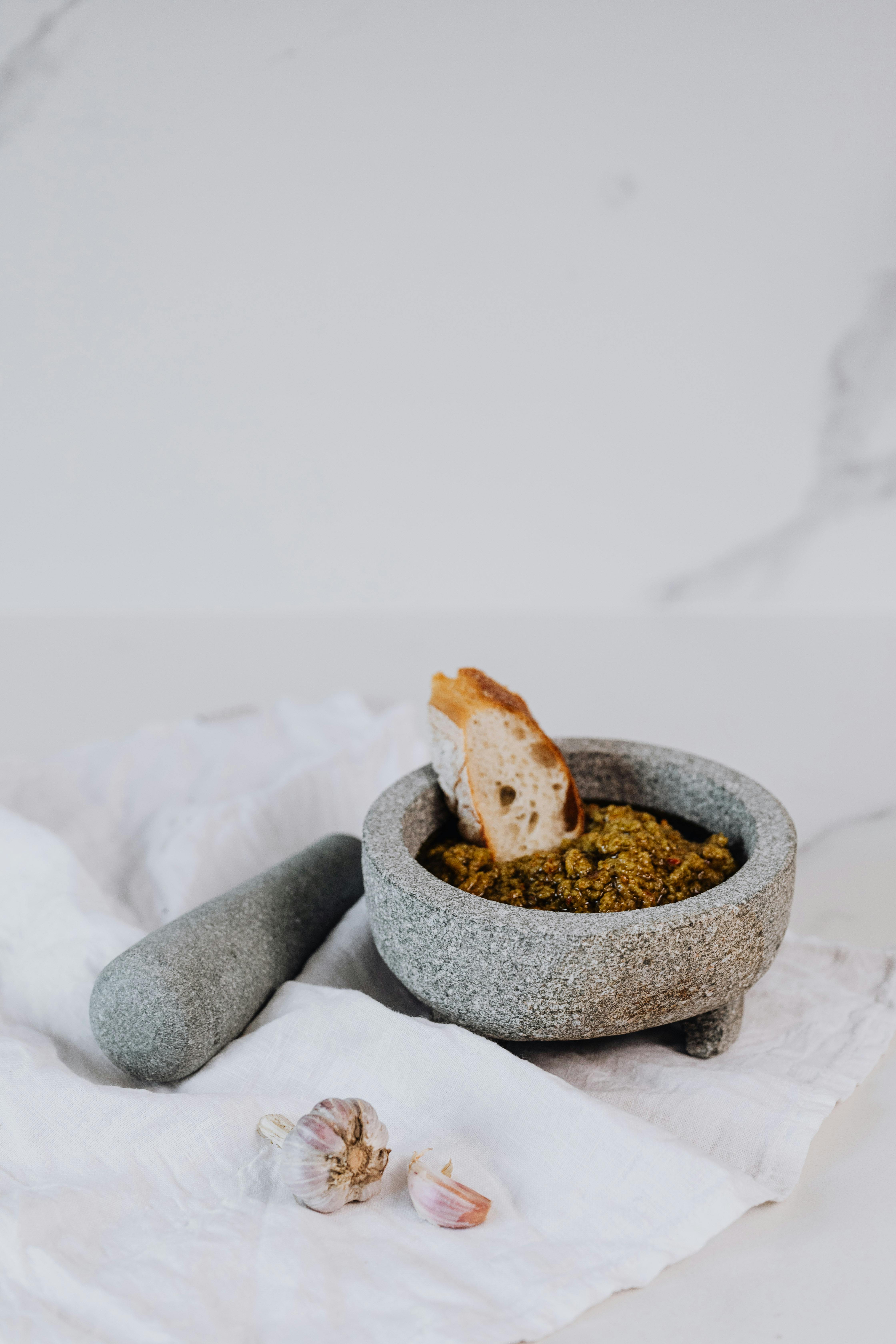 CloseUp Shot of Mortar and Pestle with Salsa and Bread · Free Stock Photo