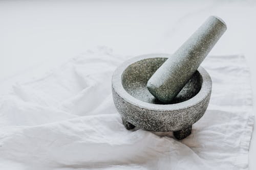 Mortar and Pestle on a White Textile 