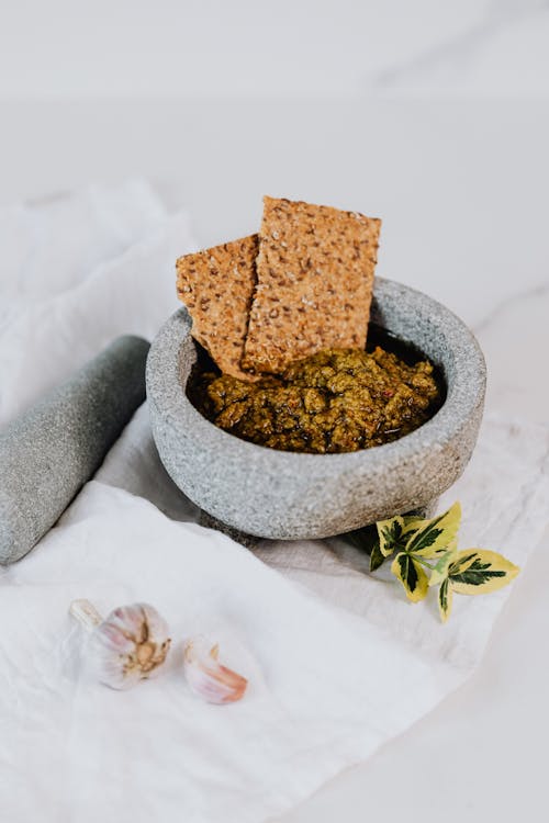 Mortar with Pesto and Crackers 