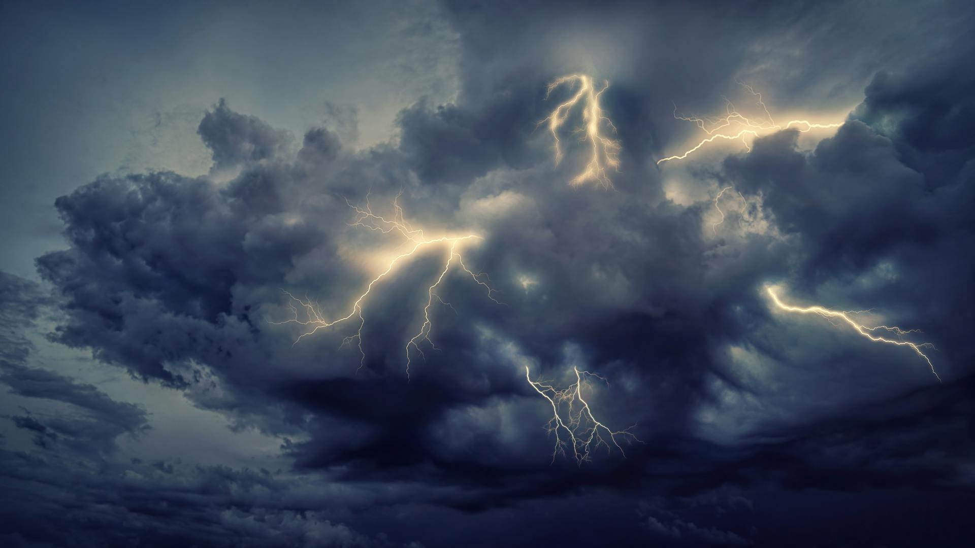 Intense cloud formation with vivid lightning strikes during a powerful storm, creating an electrifying scene.