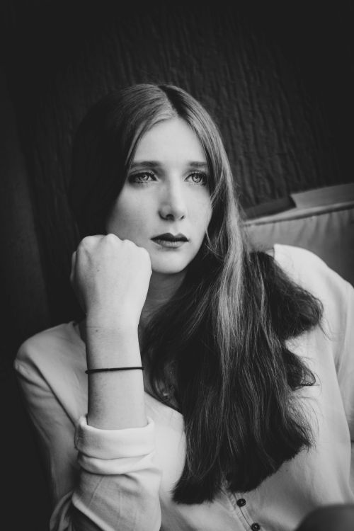 Free Stunning black and white portrait of a young woman with thoughtful expression. Stock Photo