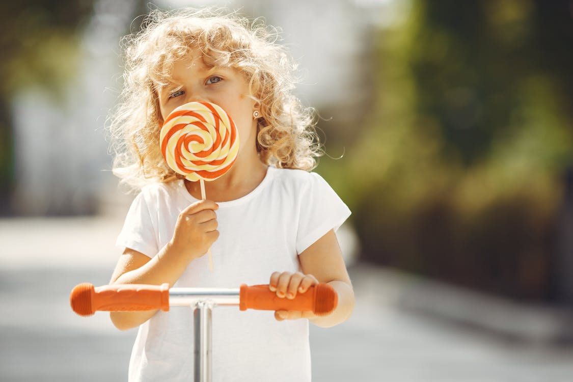 A Girl Holding a Lollipop