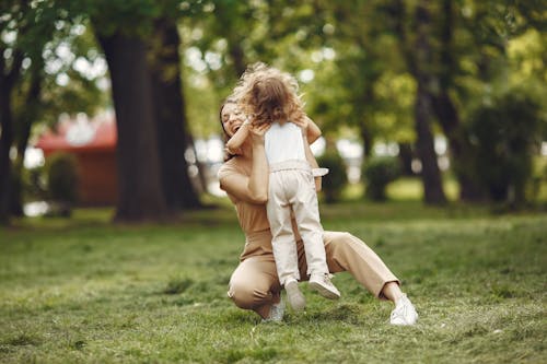 Free Mother and Her Daughter Playing on the Grass Stock Photo