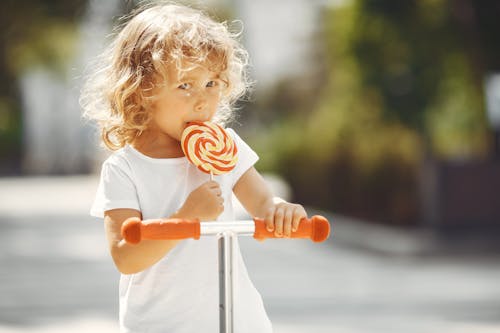 A Kid Eating a Lollipop