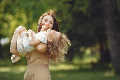 Close-Up Shot of a Mother Carrying her Daughter 