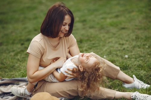 Free Happy mother and daughter enjoying playful time together outdoors, capturing love and laughter. Stock Photo