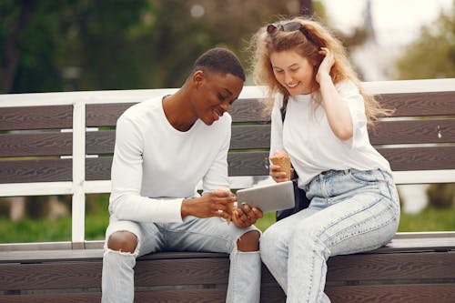 A Man and a Woman Sitting on Bench