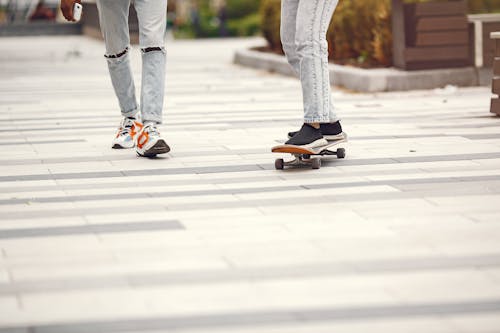 Free A Person in Denim Pants using a Skateboard Stock Photo