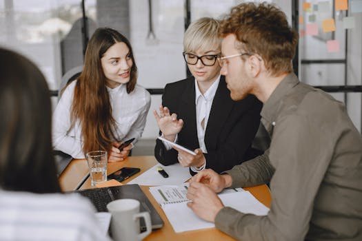 Professional team collaborating in a modern office meeting room, discussing strategies.