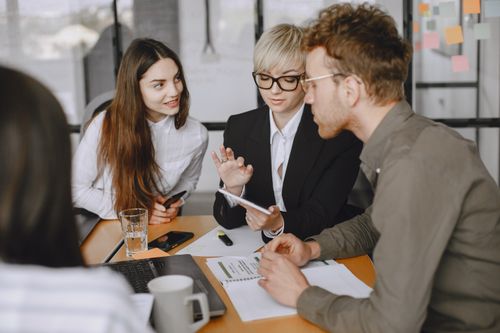 Free Professional team collaborating in a modern office meeting room, discussing strategies. Stock Photo