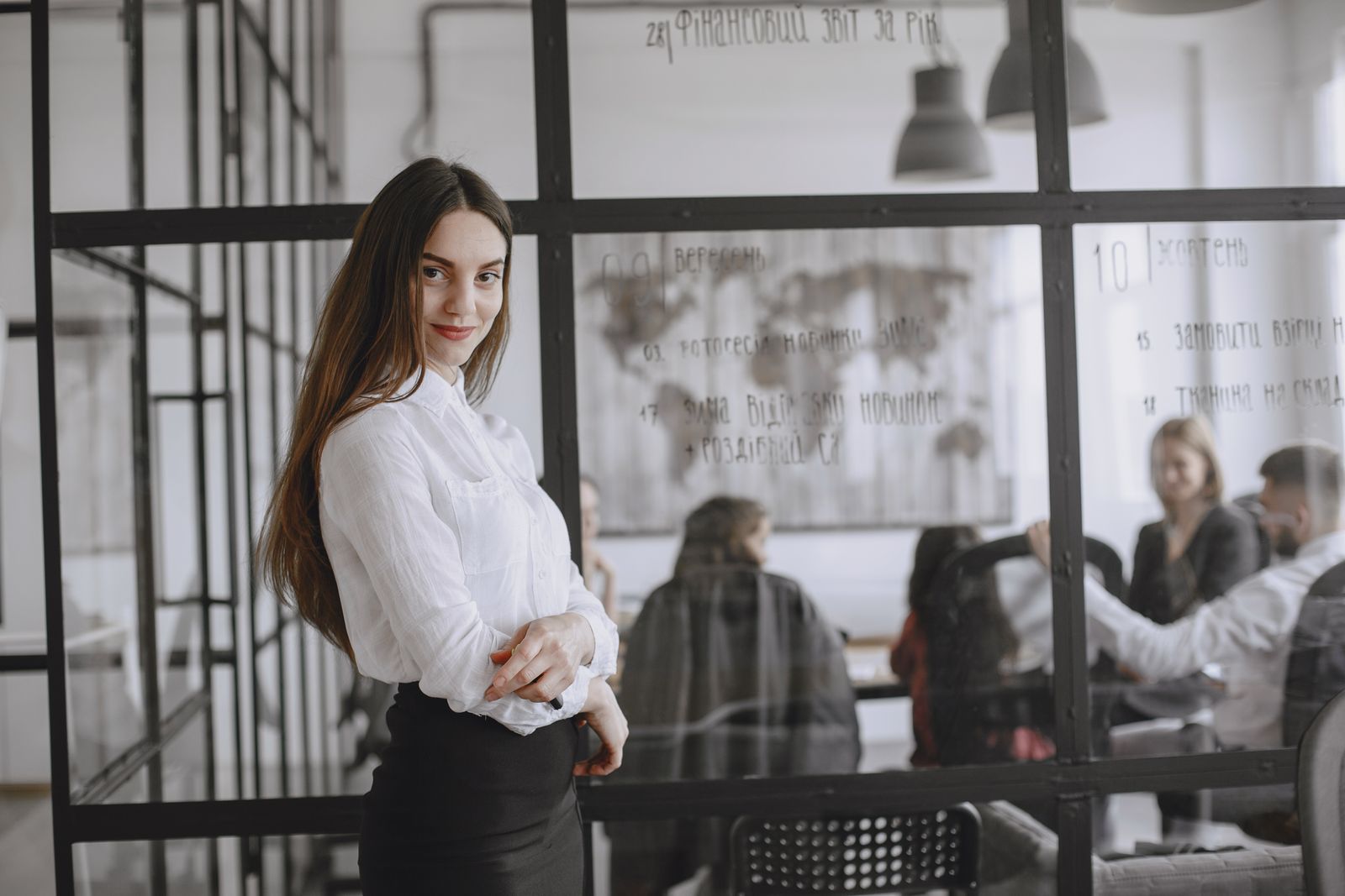 Maya Ellis standing confidently with a warm smile in her office