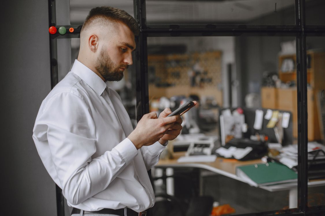 A Man Using a Smart Phone · Free Stock Photo
