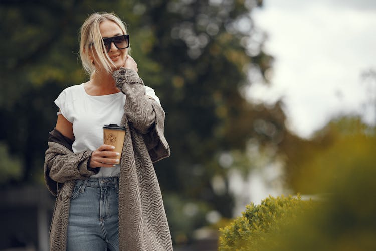 Happy Young Woman Walking With Takeaway Coffee