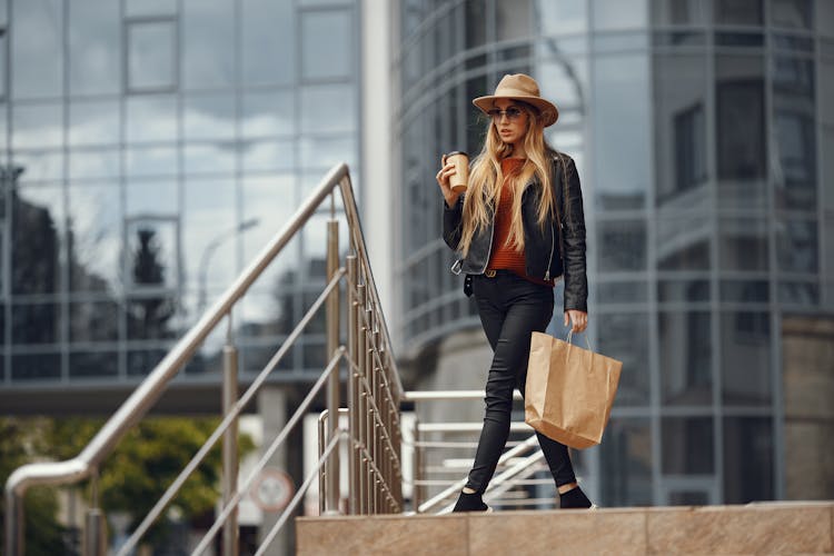 Young Woman With Shopping Bag And Takeaway Coffee