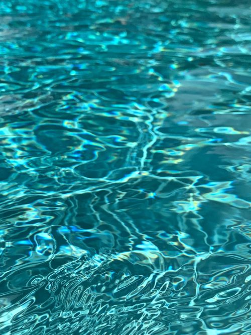 Free Close-up of turquoise water with gentle ripples reflecting light, creating a calming effect. Stock Photo