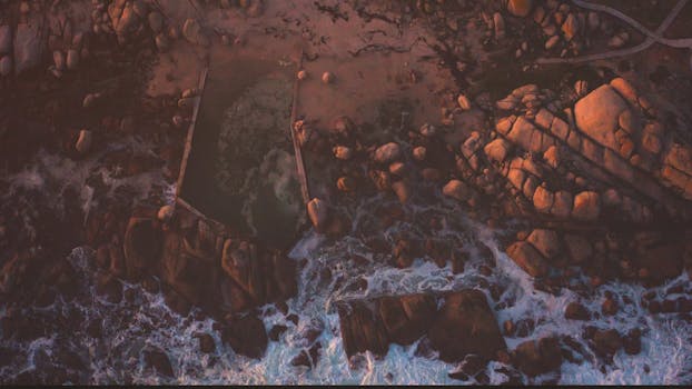 Stunning aerial shot of Cape Town's rocky coastline at dusk, showcasing natural beauty.