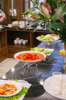 Buffet table with fresh salads and elegant presentation in a restaurant setting in Hanoi, Vietnam.