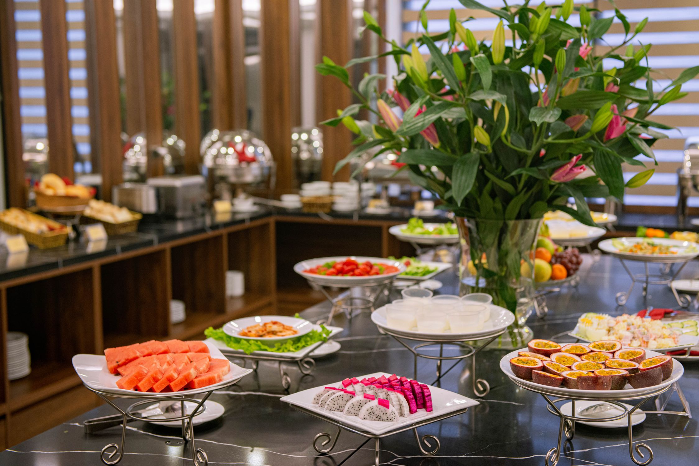 A vibrant hotel breakfast buffet featuring fresh fruits and snacks.