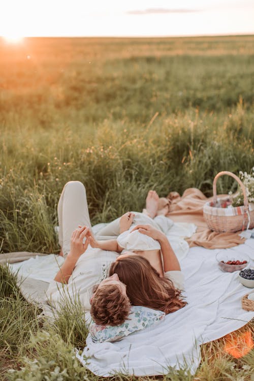 Free Man And Woman Lying On A Picnic Blanket Stock Photo