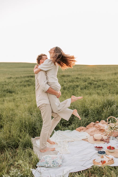 Man Carrying Woman In The Middle Of A Field
