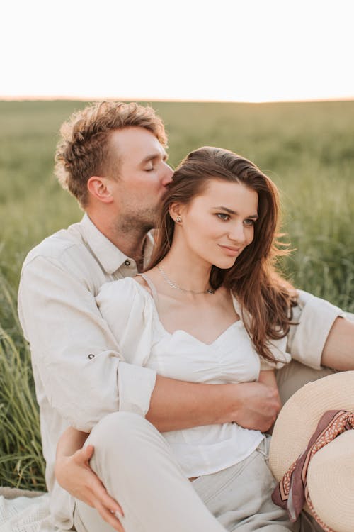 Man In White Dress Shirt Kissing Woman On The Head