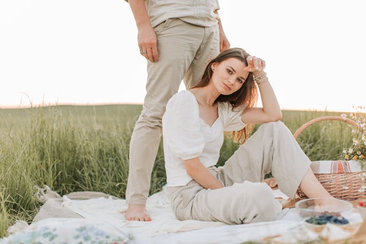 Man Standing Behind Woman