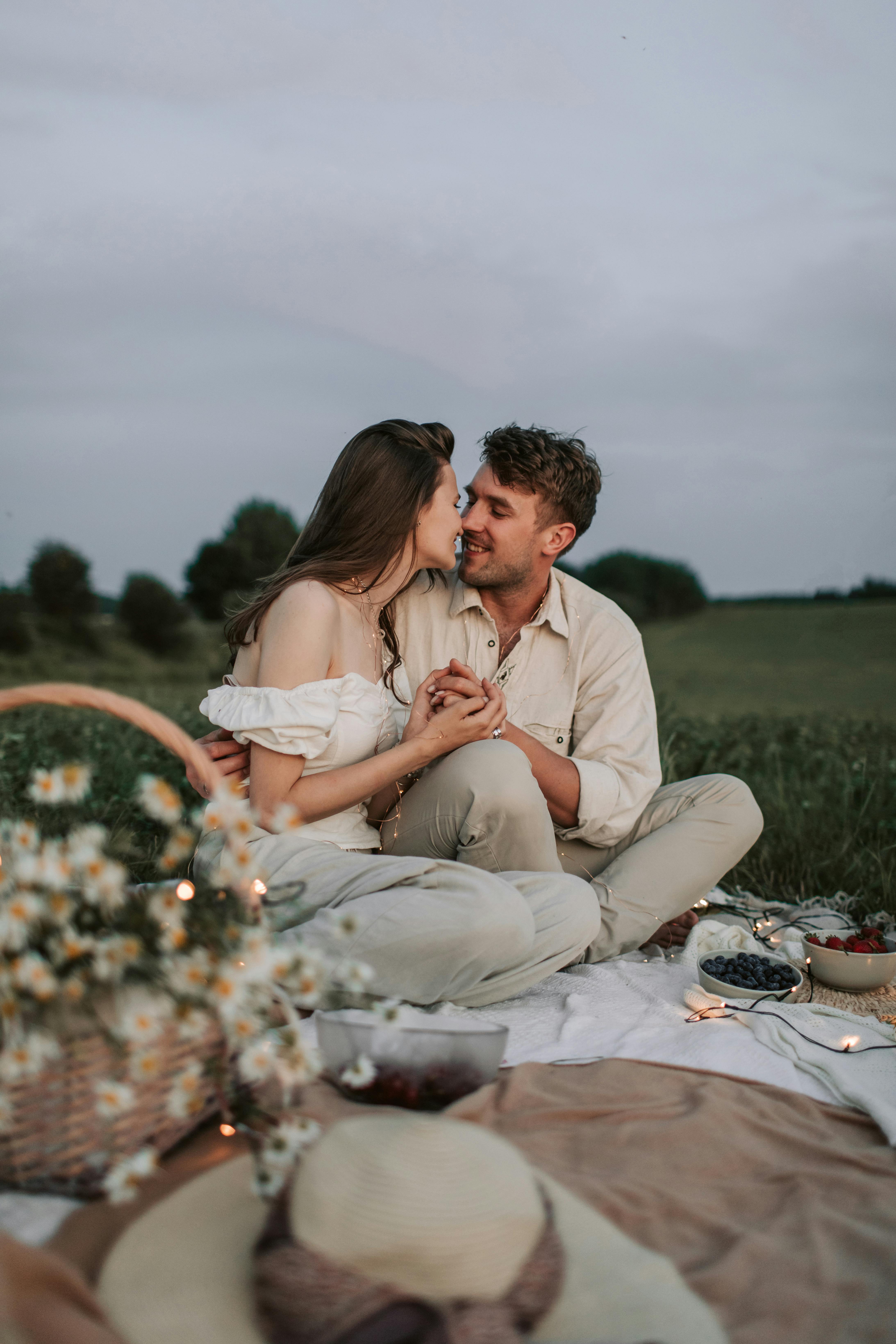 a couple sitting on the ground