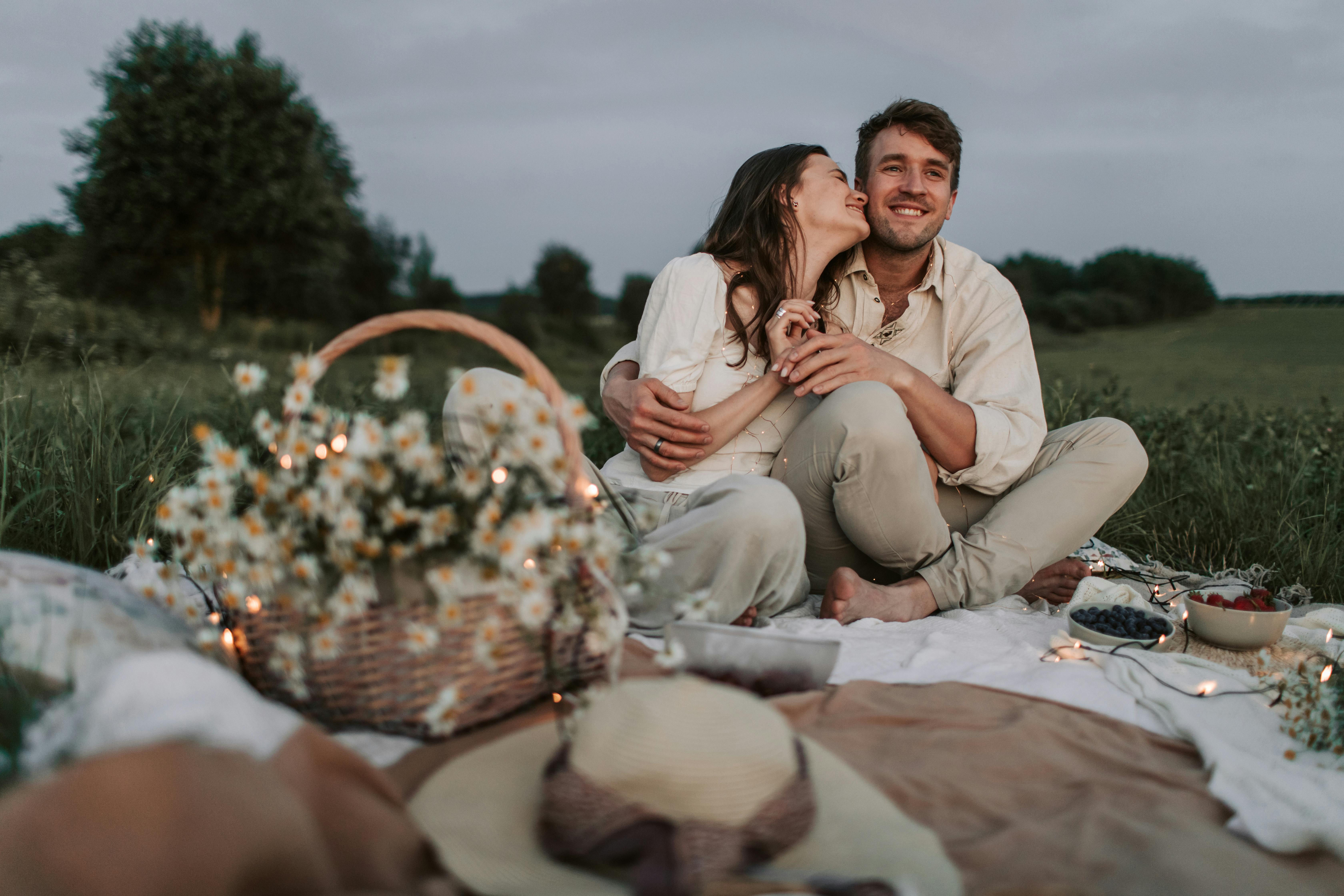 a couple sitting on the ground