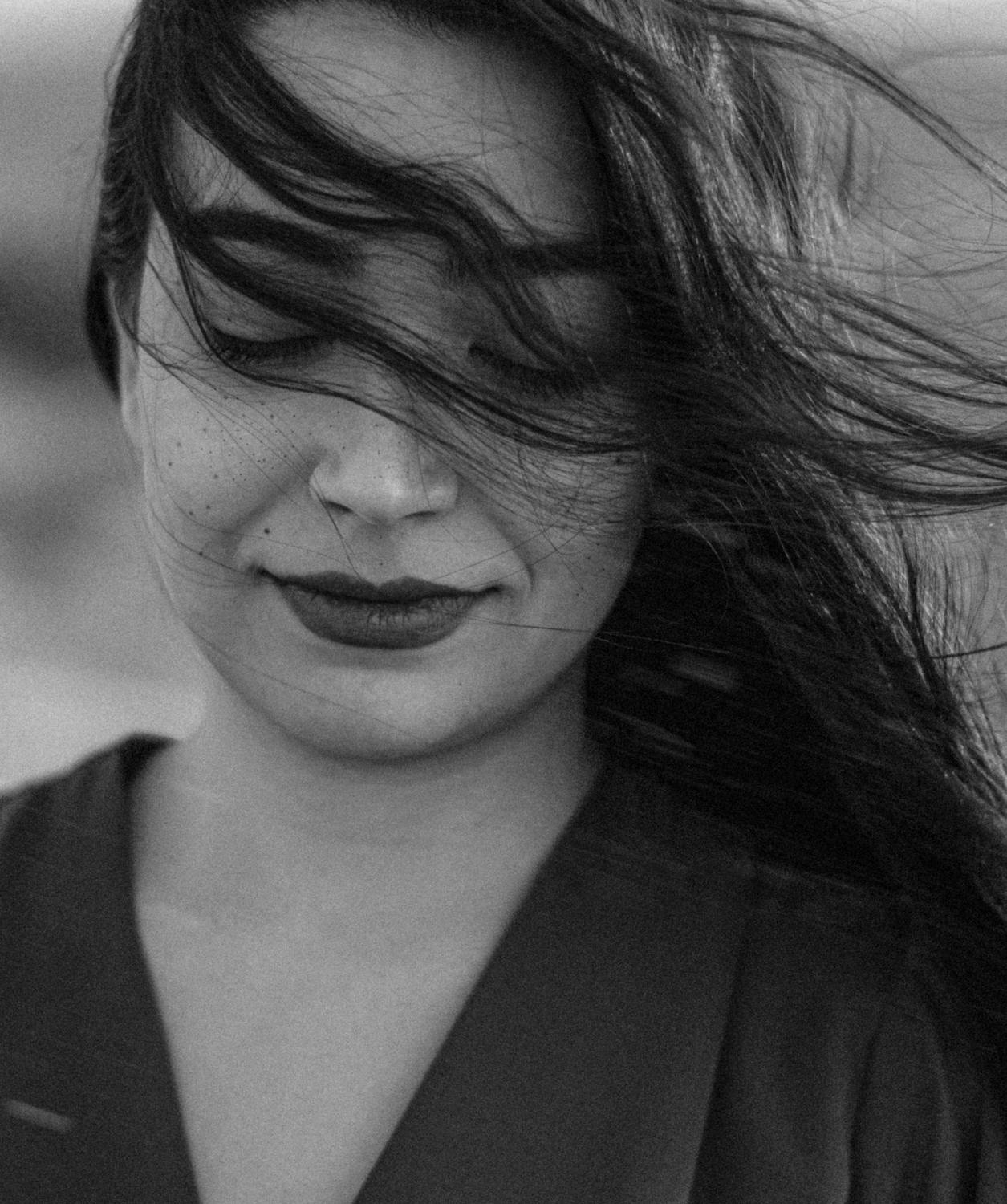 b&w of woman's hair in face