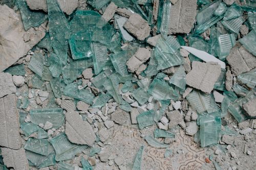 Free Detailed close-up of shattered glass fragments and concrete rubble showcasing texture. Stock Photo
