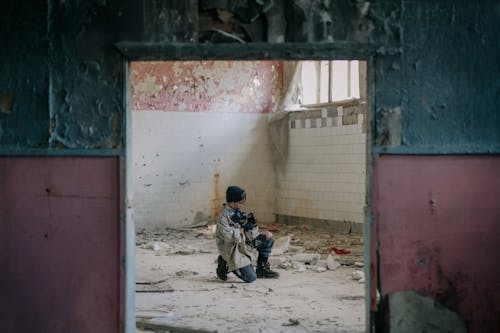 Man in Black Jacket Sitting on Floor